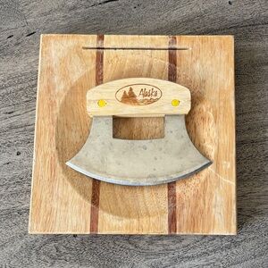Vintage Alaskan ulu knife set, includes curved knife and a chopping board.